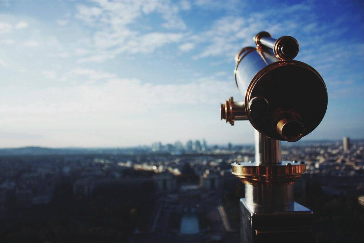 Brass telescope overlooking a city skyline